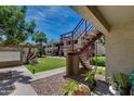 Exterior view of an apartment complex with stairs and landscaping at 3301 E Earll Dr # 219, Phoenix, AZ 85018