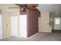 An interior view with neutral walls, a ceiling fan, and access to the kitchen area at 3301 E Earll Dr # 219, Phoenix, AZ 85018