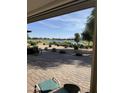 Relaxing back patio with comfortable seating and panoramic view of the golf course and lake at 36047 N Copper Hollow Way, Queen Creek, AZ 85140