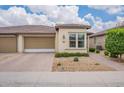 Charming single-story home with a well-manicured front yard and a two-car garage at 36047 N Copper Hollow Way, Queen Creek, AZ 85140