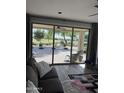 Open concept living room showcasing golf course view from oversized glass sliding doors at 36047 N Copper Hollow Way, Queen Creek, AZ 85140