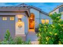 Charming single-story home featuring a tile roof, desert landscaping, and a welcoming orange front door at 490 W Encinas St, Gilbert, AZ 85233