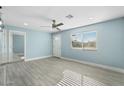 Inviting living room with a large window, ceiling fan, and new floors at 5011 S 20Th Pl, Phoenix, AZ 85040