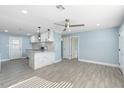 Open-concept living room flowing into the kitchen featuring an island and recessed lighting at 5011 S 20Th Pl, Phoenix, AZ 85040