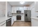 Modern kitchen featuring stainless steel appliances, white cabinets, and subway tile backsplash at 5401 E Van Buren St # 1004, Phoenix, AZ 85008