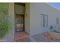 Close up of the front door with a secure iron screen and brick landing at 629 E State Ave, Phoenix, AZ 85020