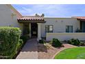 View of front entrance with well manicured shrubs and a red tiled roof at 629 E State Ave, Phoenix, AZ 85020