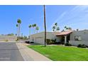 Charming single story home with a lush green lawn and a two car garage from street at 629 E State Ave, Phoenix, AZ 85020