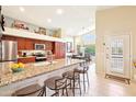 Bright kitchen with granite countertops, stainless steel appliances, and a breakfast bar with seating at 6439 W Kristal Way, Glendale, AZ 85308