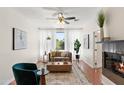 Bright living room with elegant decor, fireplace, and a ceiling fan creating a welcoming atmosphere at 6900 E Princess Dr # 2247, Phoenix, AZ 85054