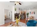Open-concept living space with fireplace, stylish decor, and view of kitchen and breakfast nook at 6900 E Princess Dr # 2247, Phoenix, AZ 85054