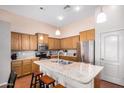 Bright kitchen with stainless steel appliances, granite countertops, a kitchen island, and pendant lighting at 726 E Heather Dr, San Tan Valley, AZ 85140