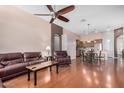 Spacious living room featuring hardwood floors, comfortable seating, a ceiling fan, and an open floor plan at 726 E Heather Dr, San Tan Valley, AZ 85140