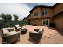 Backyard patio featuring comfortable seating and a fire pit at 8023 N 49Th Ave, Glendale, AZ 85302