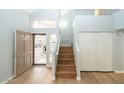 Spacious entryway with high ceilings, wood flooring, and a staircase leading to the upper level, creating an open feel at 909 W San Mateo Ct, Gilbert, AZ 85233