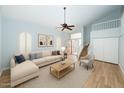 Inviting living room with wood floors, vaulted ceiling, and a comfortable sofa creates a relaxing atmosphere at 909 W San Mateo Ct, Gilbert, AZ 85233