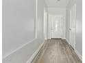 Bright hallway featuring wood floors and a decorative glass front door at 9224 W Raymond St, Tolleson, AZ 85353