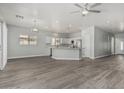 Spacious living room with light gray walls and wood laminate flooring throughout at 9224 W Raymond St, Tolleson, AZ 85353