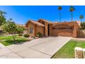 Inviting home exterior with mature landscaping and a spacious driveway at 1214 W Sand Dune Dr, Gilbert, AZ 85233