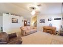 Spacious living area with plush carpeting, a piano, and comfortable leather seating at 1219 E Avenida Isabela --, Casa Grande, AZ 85122