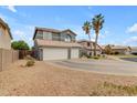 Beautiful house with a three-car garage, xeriscaping, and lush landscaping with mature trees at 1405 S Honeysuckle Cir, Gilbert, AZ 85296