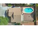 Aerial view of backyard oasis with pool, patio, and privacy fencing with mature landscaping at 14626 N 132Nd Ave, Surprise, AZ 85379