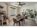 Cozy dining room with modern light fixture, neutral colors and wood-look tile flooring at 1540 E Glencove St, Mesa, AZ 85203