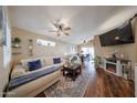 Bright living room with hardwood floors, ceiling fan, and a modern fireplace at 16036 W Desert Bloom St, Goodyear, AZ 85338