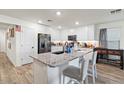 Bright, updated kitchen with granite countertops, white cabinets, and stainless steel appliances at 17461 W Molly Ln, Surprise, AZ 85387