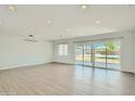 Bright and spacious living room with sleek flooring and sliding glass doors to the backyard at 1930 E Missouri Ave, Phoenix, AZ 85016