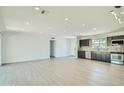 Open-concept living room with sleek floors connecting to a modern kitchen at 1930 E Missouri Ave, Phoenix, AZ 85016