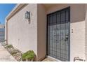 Inviting front entry with decorative security door, desert landscaping, and exterior lighting at 2326 E Evans Dr, Phoenix, AZ 85022