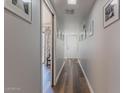 Entry hallway featuring wood-look floors, neutral paint, and access to the living spaces at 2326 E Evans Dr, Phoenix, AZ 85022