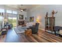 Open living room with fireplace, hardwood floors, clerestory windows, and a ceiling fan at 2326 E Evans Dr, Phoenix, AZ 85022