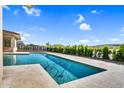 Sparkling backyard pool featuring a cleaning system and lush landscaping at 24138 S 220Th St, Queen Creek, AZ 85142