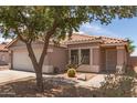 Charming single-story home featuring a two-car garage, desert landscaping, and a tiled roof at 2710 S Shelby --, Mesa, AZ 85209