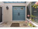 Inviting entrance with double doors, decorative hardware, and a stone tile entryway at 2916 S Revere Cir, Mesa, AZ 85210