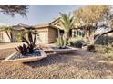 Charming home featuring desert landscaping, with stone planters and a desert-scape yard at 3212 E Desert Cove Ave, Phoenix, AZ 85028