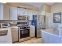 Well-equipped kitchen featuring stainless steel appliances, ample cabinetry, and modern countertops at 3212 E Desert Cove Ave, Phoenix, AZ 85028