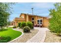 Inviting home featuring a stucco exterior, manicured landscaping, and cozy front patio seating at 3358 W Sandra Ter, Phoenix, AZ 85053