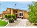 Inviting front exterior with a well-maintained lawn, brick pathway, and comfortable outdoor seating at 3358 W Sandra Ter, Phoenix, AZ 85053