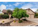 Charming desert home with desert landscaping, a three-car garage, and a rock water feature at 3460 N Stone Gully St, Mesa, AZ 85207