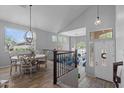 Open-concept living area with vaulted ceilings, abundant natural light, and stylish dining area at 35746 N 32Nd Ln, Phoenix, AZ 85086