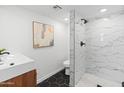 Modern bathroom features a walk-in shower with sleek fixtures, vanity sink and hexagon tile flooring at 3824 W Puget Ave, Phoenix, AZ 85051