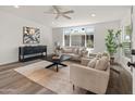 A bright living room features modern decor, neutral tones, wood-look floors and plenty of natural light at 3824 W Puget Ave, Phoenix, AZ 85051
