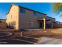 Large backyard with a covered patio, desert landscaping, and a concrete area at 4187 N 298Th Ln, Buckeye, AZ 85396