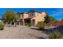 Attractive desert landscaping surrounds the front yard of this two-story home at 4187 N 298Th Ln, Buckeye, AZ 85396
