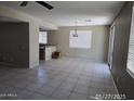 Open living room with tile floors and large windows allowing for natural light at 43455 W Chisholm Dr, Maricopa, AZ 85138