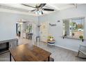 Inviting living area with a cozy ambiance featuring a ceiling fan and a large window at 439 N Cherry --, Mesa, AZ 85201