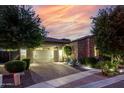 Charming stone home with manicured landscaping and warm exterior lighting at 4519 N 29Th Way, Phoenix, AZ 85016